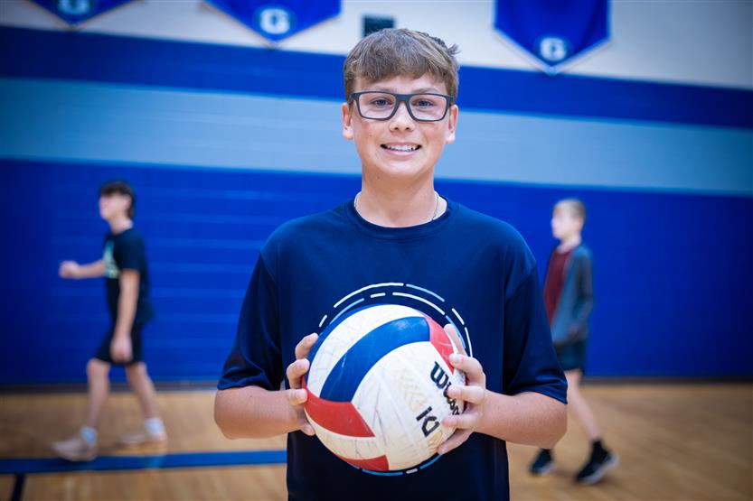 Students play volleyball in PE